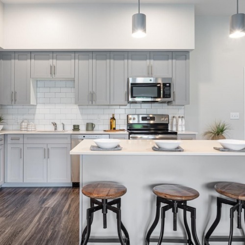 Spacious kitchens with thoughtful details a kitchen with an island and stools