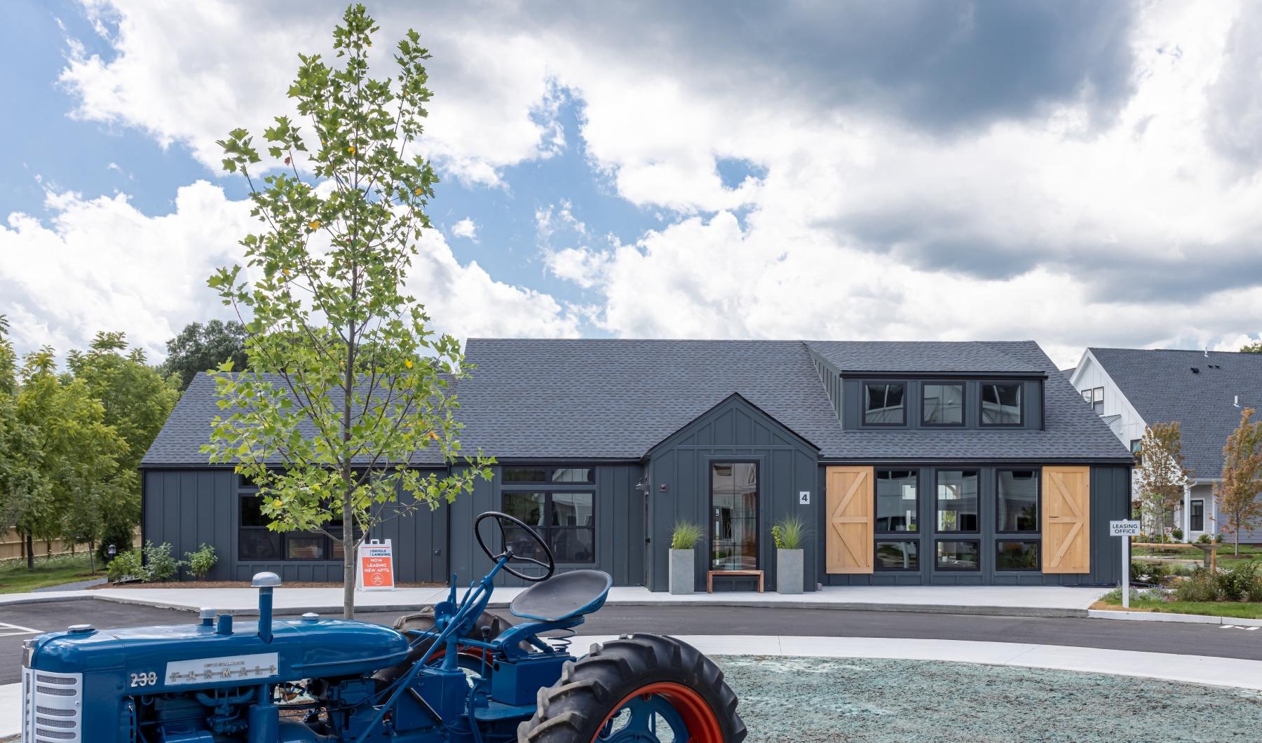 Settle into comfort at Oriole Landing a building with a blue tractor in front of it