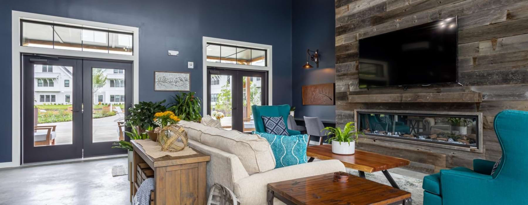 a lounge with a fireplace couch and tv