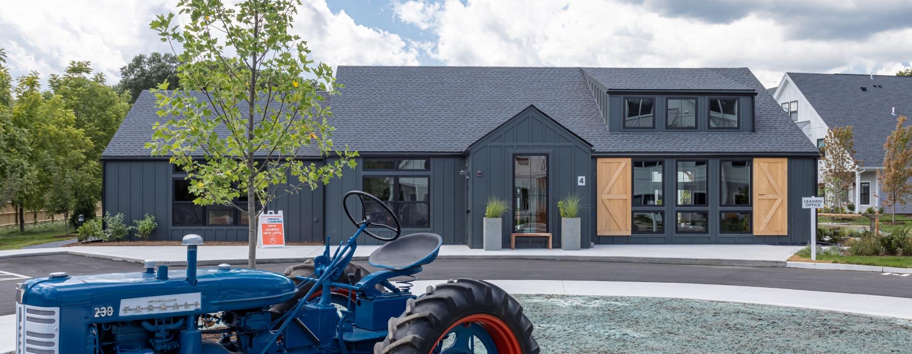 a building with a blue tractor in front of it